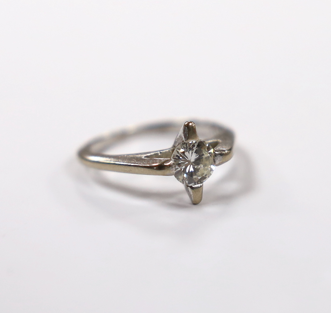 A modern white metal and solitaire diamond set ring, size K, gross weight 3.5 grams.